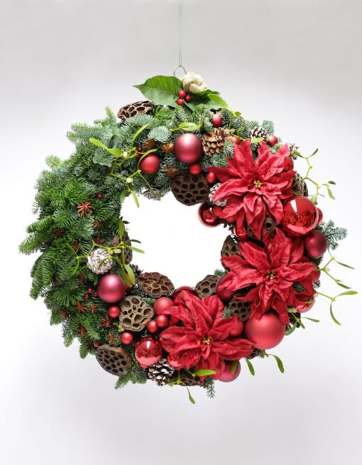 A wreath decorated with poinsettias
