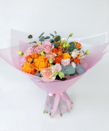 A bouquet of orange roses, pink roses, cream carnations and pink eustomas