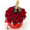 A box of red roses with a bottle of Moet champagne