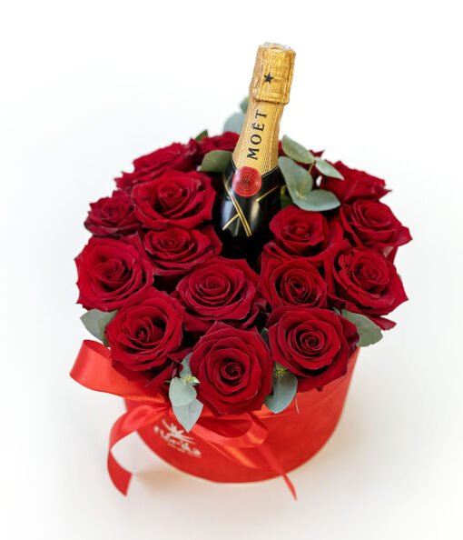 A box of red roses with a bottle of Moet champagne