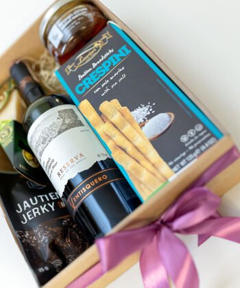 A box with red wine and delicious snacks