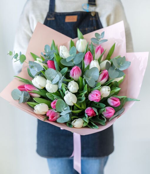 Bouquet of whote and pink tulips in the hands